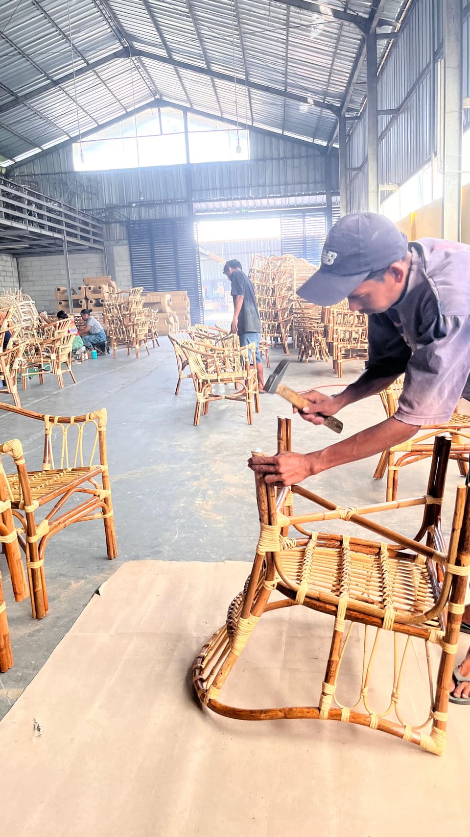 Craftsman assembling a rattan chair frame